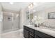 Elegant bathroom features a double vanity, granite countertops, and glass-enclosed shower at 133 Explorer Dr # 258, Morrisville, NC 27560