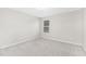Neutral bedroom with light gray walls, carpeted floors, and a window for natural light at 133 Explorer Dr # 258, Morrisville, NC 27560