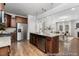 Open concept kitchen featuring granite countertops, a stainless steel refrigerator, and hardwood floors at 133 Explorer Dr # 258, Morrisville, NC 27560