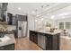 Kitchen showcasing dark cabinets, center island with seating, and stainless steel appliances at 133 Explorer Dr # 258, Morrisville, NC 27560