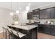 Kitchen with dark cabinets, island with seating, and stainless steel appliances at 133 Explorer Dr # 258, Morrisville, NC 27560