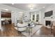 Spacious living room featuring hardwood floors, a cozy fireplace, and lots of natural light at 133 Explorer Dr # 258, Morrisville, NC 27560