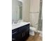 This clean bathroom features a dark vanity, large mirror, and a glass door shower at 142 Philips Sq, Chapel Hill, NC 27516