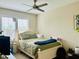 Bedroom with white wooden bed, ceiling fan, and bright natural light from the window at 142 Philips Sq, Chapel Hill, NC 27516