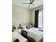 Cozy bedroom offers a ceiling fan, window with curtains, and a nightstand with a table lamp at 142 Philips Sq, Chapel Hill, NC 27516