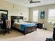 Cozy bedroom featuring a wooden bed frame, ceiling fan, and bright natural light at 142 Philips Sq, Chapel Hill, NC 27516
