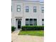 Charming townhome with gray siding, black trim, manicured lawn, and sidewalk at 142 Philips Sq, Chapel Hill, NC 27516