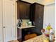 Close-up of a kitchen with dark cabinets, featuring granite countertops and modern appliances at 142 Philips Sq, Chapel Hill, NC 27516