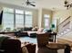 Spacious living room features a large window, stylish decor, and staircase at 142 Philips Sq, Chapel Hill, NC 27516