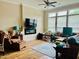Bright living room with a ceiling fan, fireplace, and large windows offering plenty of natural light at 142 Philips Sq, Chapel Hill, NC 27516