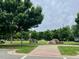 Picturesque park with lush green trees, walking paths, and a serene bench at 142 Philips Sq, Chapel Hill, NC 27516