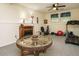 Finished basement features a wagon wheel table, fireplace, and exercise equipment at 1509 Elkpark Dr, Raleigh, NC 27610