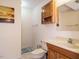 Bathroom with wooden vanity, a marble tile floor and a storage cabinet at 1509 Elkpark Dr, Raleigh, NC 27610