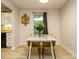 Bright dining area featuring modern decor, a stylish table setting, and a large window offering pleasant views at 1509 Elkpark Dr, Raleigh, NC 27610