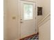 Elegant front door featuring decorative glass panel, complemented by classic hardware and a clean white finish at 1509 Elkpark Dr, Raleigh, NC 27610