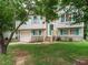 Inviting two-story home with teal shutters, mature trees, and a nicely landscaped front yard and attached one-car garage at 1509 Elkpark Dr, Raleigh, NC 27610