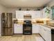 Bright kitchen featuring stainless steel appliances and ample cabinet space for storage at 1509 Elkpark Dr, Raleigh, NC 27610