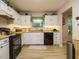 Well-lit kitchen features wooden countertops and under-cabinet lighting for added convenience at 1509 Elkpark Dr, Raleigh, NC 27610