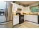 Bright kitchen featuring stainless steel appliances and ample cabinet space for storage at 1509 Elkpark Dr, Raleigh, NC 27610