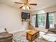 Inviting living room with modern ceiling fan, stylish furnishings, and ample natural light and wood plank flooring at 1509 Elkpark Dr, Raleigh, NC 27610