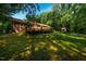 Lush backyard featuring a deck and mature trees offering shade and privacy at 1511 Hatch Rd, Chapel Hill, NC 27516