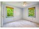 Carpeted bedroom with natural light from two windows at 1511 Hatch Rd, Chapel Hill, NC 27516