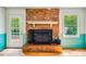 Brick fireplace with a hearth and wood burning stove at 1511 Hatch Rd, Chapel Hill, NC 27516