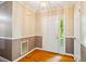 Bright foyer with hardwood floors, decorative wallpaper, and a classic entry door at 1511 Hatch Rd, Chapel Hill, NC 27516