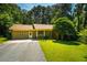 Charming home exterior with lawn and mature trees, set back from the road at 1511 Hatch Rd, Chapel Hill, NC 27516