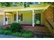 Charming front porch with brick base, columns, and ample space for seating at 1511 Hatch Rd, Chapel Hill, NC 27516
