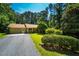 Charming home featuring a lush front yard, mature trees, and an attached garage, nestled in a serene, wooded neighborhood at 1511 Hatch Rd, Chapel Hill, NC 27516