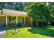 Inviting home featuring a well-manicured front yard and classic brick accents at 1511 Hatch Rd, Chapel Hill, NC 27516