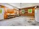 Spacious garage with workbench area, storage shelving, and a refrigerator at 1511 Hatch Rd, Chapel Hill, NC 27516