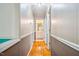 Hallway with hardwood floors leading to a bathroom at 1511 Hatch Rd, Chapel Hill, NC 27516
