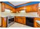 Traditional kitchen featuring wooden cabinets, quartz countertops, and stainless steel appliances at 1511 Hatch Rd, Chapel Hill, NC 27516