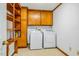Functional laundry room with storage shelves and washer and dryer at 1511 Hatch Rd, Chapel Hill, NC 27516