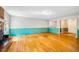 Large living room featuring hardwood floors, a brick fireplace, and ample natural light at 1511 Hatch Rd, Chapel Hill, NC 27516