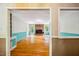 Open living room featuring hardwood floors, a brick fireplace, and ample natural light at 1511 Hatch Rd, Chapel Hill, NC 27516
