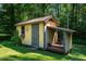 Yellow shed in backyard with covered area for storage at 1511 Hatch Rd, Chapel Hill, NC 27516