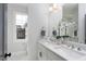 Elegant bathroom features double sinks, a large mirror, and a window for natural light at 1514 W Knox St, Durham, NC 27705