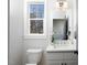 Bright bathroom with white vanity, quartz countertop, and modern fixtures at 1514 W Knox St, Durham, NC 27705