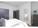 Bright bedroom featuring a walk-in closet and bathroom with tiled floors at 1514 W Knox St, Durham, NC 27705