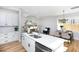 Open-concept kitchen with island seating, stainless steel appliances, and adjacent dining area at 1514 W Knox St, Durham, NC 27705