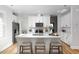 Stylish kitchen with an island, white cabinetry, stainless steel appliances, and hardwood floors at 1514 W Knox St, Durham, NC 27705