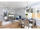 Sunlit living and dining area featuring hardwood floors and modern chandelier at 1514 W Knox St, Durham, NC 27705