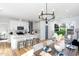 Open living space with a kitchen island, dining area, and living room with natural light at 1514 W Knox St, Durham, NC 27705