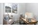 Cozy office space with a wooden desk, accent chair, and natural light from a large window at 1514 W Knox St, Durham, NC 27705