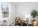 Bright office space featuring a large window, wooden desk, and neutral decor at 1514 W Knox St, Durham, NC 27705