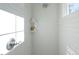 The shower features sleek white tile, built-in shelves, and modern fixtures at 1514 W Knox St, Durham, NC 27705
