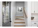 Stairway featuring hardwood steps, white risers, and natural light from a nearby window at 1514 W Knox St, Durham, NC 27705